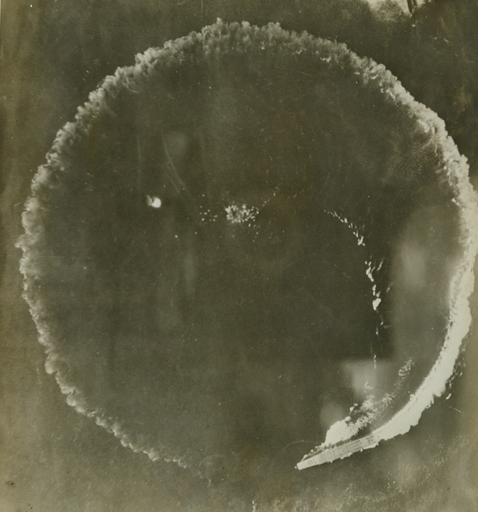Circle of Terror, 12/30/1942. This unusual photo taken by a U.S. Army photographer flying in a B-17 bomber, one of an attacking formation, shows a Jap aircraft carrier making a perfect circle in its attempt to dodge American aerial bombs, near Midway island. Credit line (U.S. Army photo from ACME);