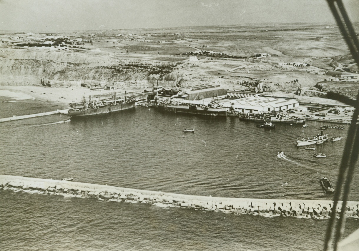 Harbor At Safi, 12/11/1942. A view of the harbor at Safi, French Morocco taken during the occupations of the North African coast by Anglo-American forces.  Note tank carrier, (center), tied up alongside dock.  This photo was just released in New York. Credit line (ACME);