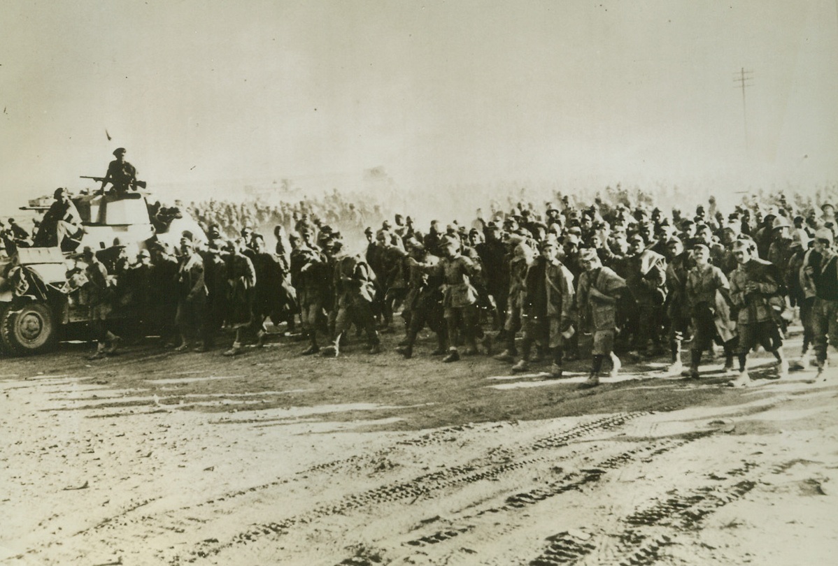 Mopping Up, 12/2/1942. Somewhere in Egypt – Not a fighting man of Rommel’s once-great Army remains in Egypt.  Photo shows New Zealanders rounding up some of the tens of thousands of prisoners taken in the desert as the British 8th Army, in rapid pursuit of the fleeing Nazis, “mops up” in Egypt.  Latest reports indicate that the 8th Army has successfully engaged Rommel’s forces at El Agheila.  Credit line (ACME);