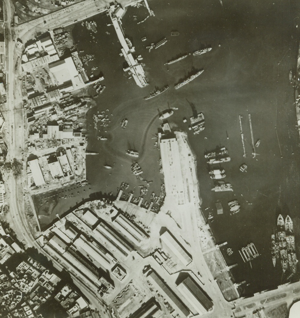 When U.S. Landed Forces in Africa, 12/1/1942. Shown above is an aerial view of the inner harbor at Casablanca, French Morocco. It was made from a U.S. plane and shows the inner harbor. The two thin lines to the right of the breakwater shows the sudden drydock, while to the left of the breakwater the small dots on the water are some of our landing barges. Effects of American shell fire are not apparent here. Credit: Official U.S. Navy photo from ACME.;