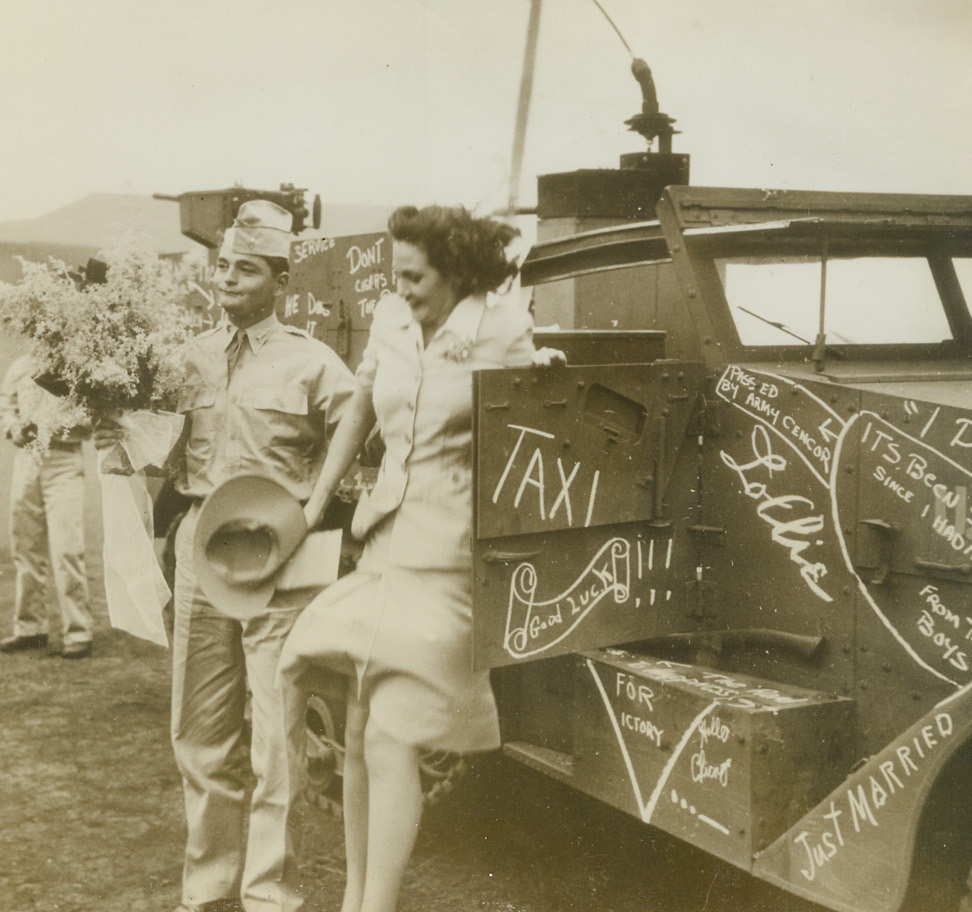 Transportation Free, 12/8/1942. Hawaii—First Lt. Donald Brattain wears a strange newly-wed smirk as he helps his bride out of the half-truck obligingly furnished—and decorated—by armored Force buddies. Young Lt. Brattain is the son of the Eastern Air Lines Vice President. His bride, Frances Masconellos, was a stenographer at an airfield in Hawaii. Now they’re man and wife and happy about the whole thing.Credit: ACME.;