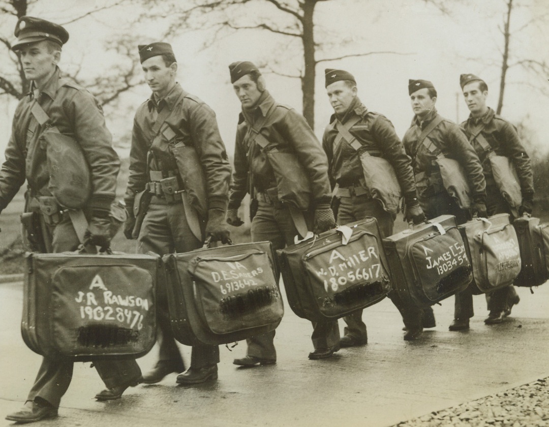 First American Sergeant Pilots in England, 12/26/1942. These American Sergeant Pilots were the first to go over to England. They are shown arriving at a replacement center. Passed by censors. Credit: ACME;
