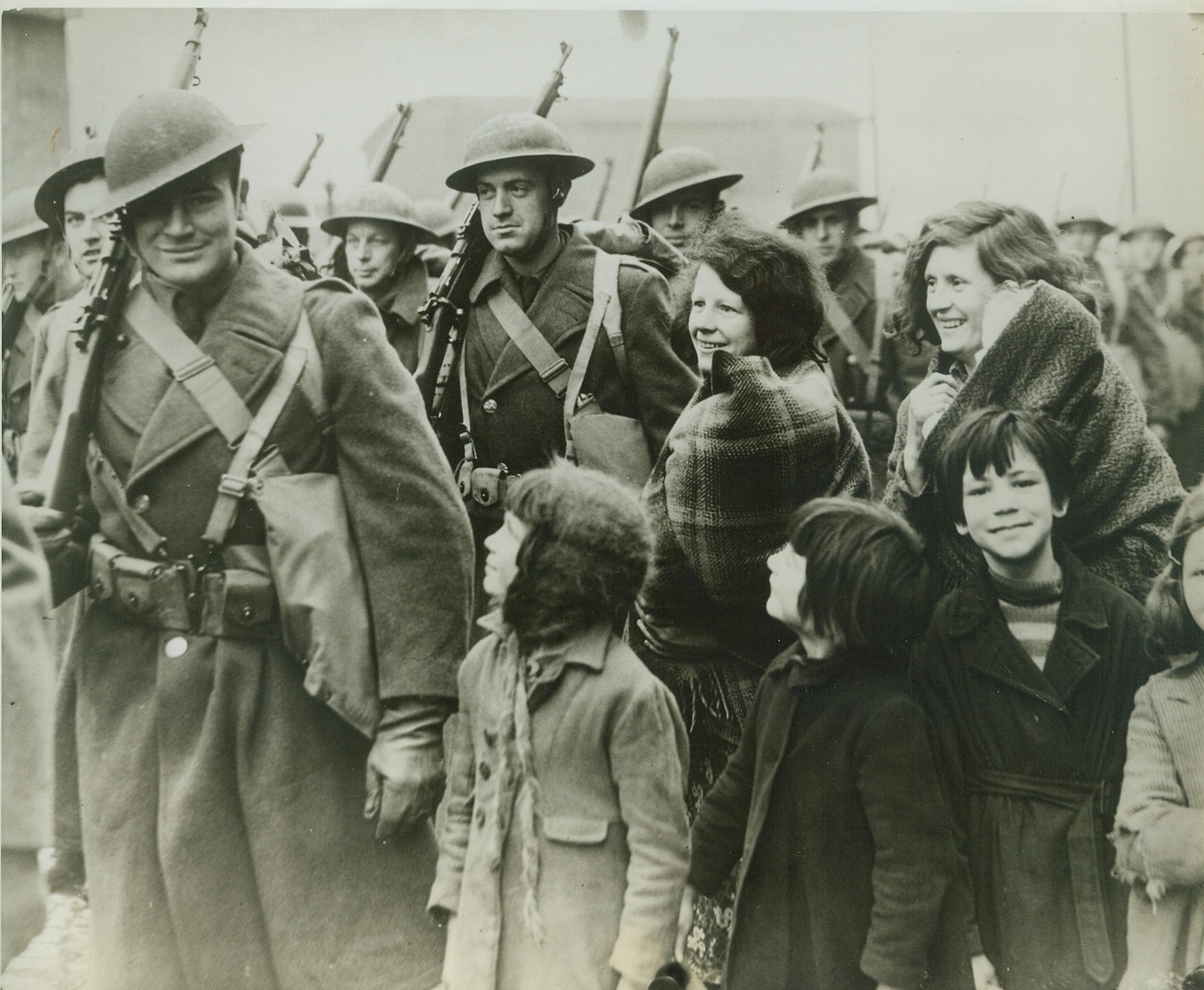 Irish Women and Children Greet American Troops, 2/8/1942. AN IRISH PORT -- Women and children in a port "somewhere in Northern Ireland" as they greeted troops of the American Expeditionary Force, on its arrival.  Credit: (ACME);