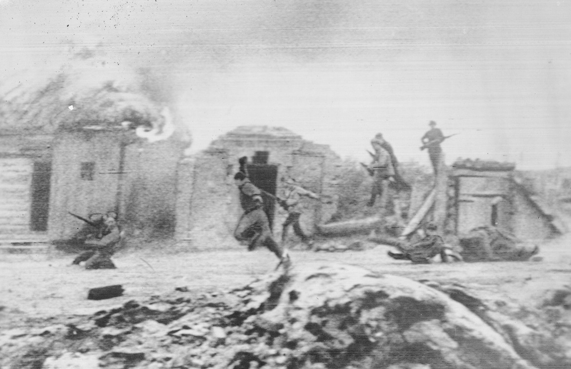 ‘March of Time”, 2/11/1942. No. 1 in this series. Russian guerillas, surprising a Nazi-Hungarian Brigade in this Russian village, cut the invaders to pieces. But a treacherous informer cost the lives of 12 brave men. Here cottages burn, men fall, during height of fighting.Credit: ACME telephoto;