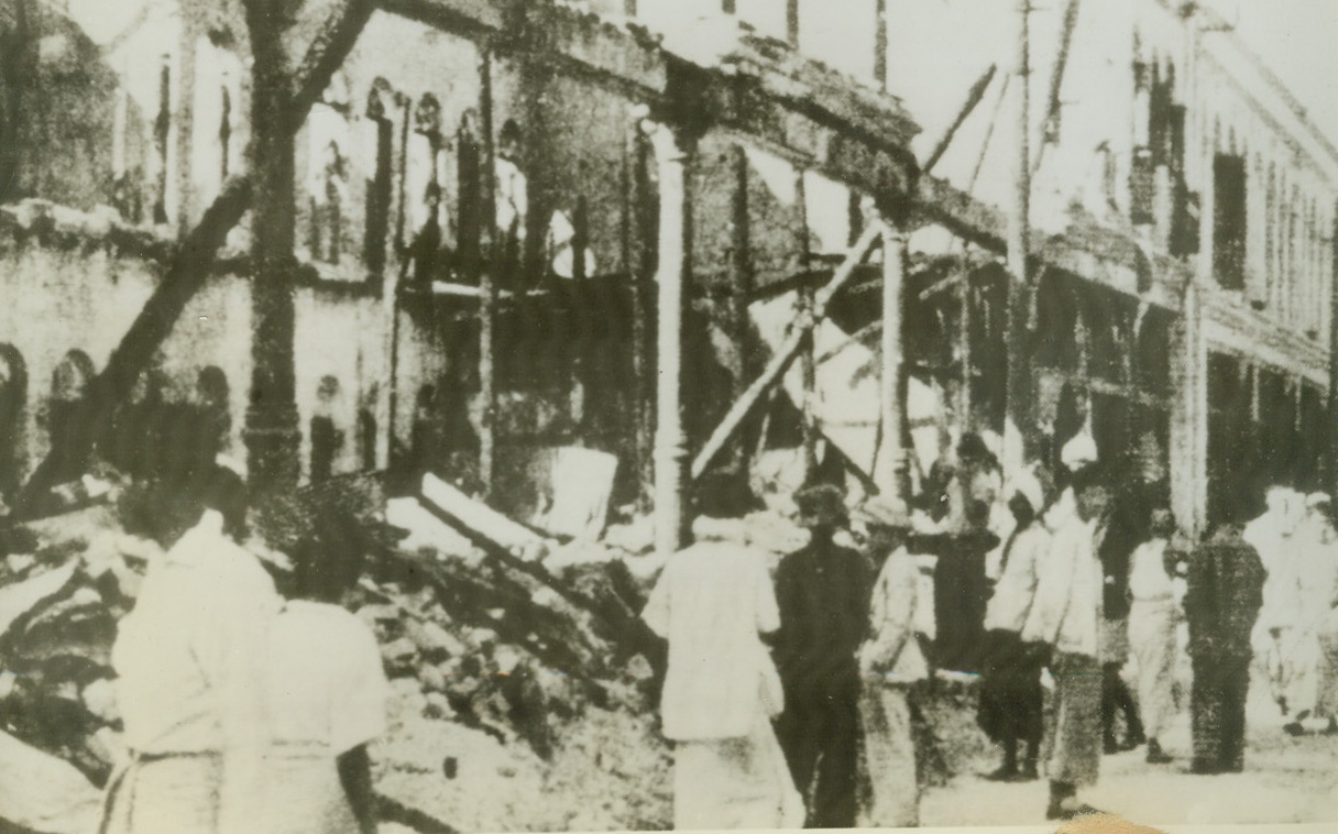 Ravaged Rangoon, 2/7/1942. Rangoon – Here’s one of the first photos to come from Burma, showing a Rangoon street ruined by raiding Jap bombers.   Yesterday morning fliers of the U.S. volunteer group of Jap raiders in a daylight engagement after the city had been pounded by waves of bombers all night.  Photo was flashed to New York from London today by radio. Credit ACME radiophoto;