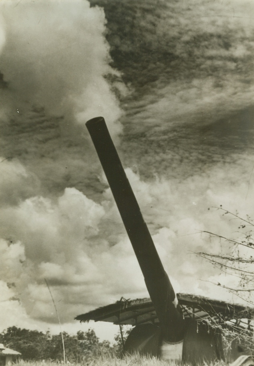 Singapore’s Big Guns Thunder, 2/5/1942. Singapore – This huge gun is typical of those which ring Singapore island strategically and which are endlessly bombarding enemy transport columns and concentrations on the Malay mainland, as British forces make a last stand on the besieged island.  These guns today blasted into silence Japanese field guns which, in new emplacements had peppered the North shore. Credit line (ACME);