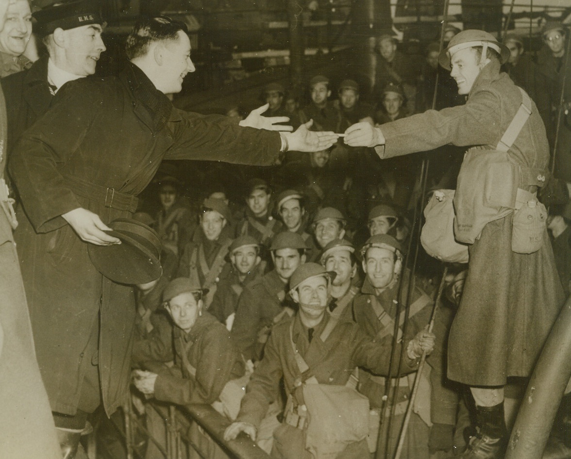 AMERICAN SOLDIERS REACH BRITISH ISLES, 2/8/1942. ULSTER, NORTHERN IRELAND—Workmen on dock in an unnamed Northern Ireland town greet members of the first U.S. expeditionary force arriving in the British Isles.  Credit Line (ACME);