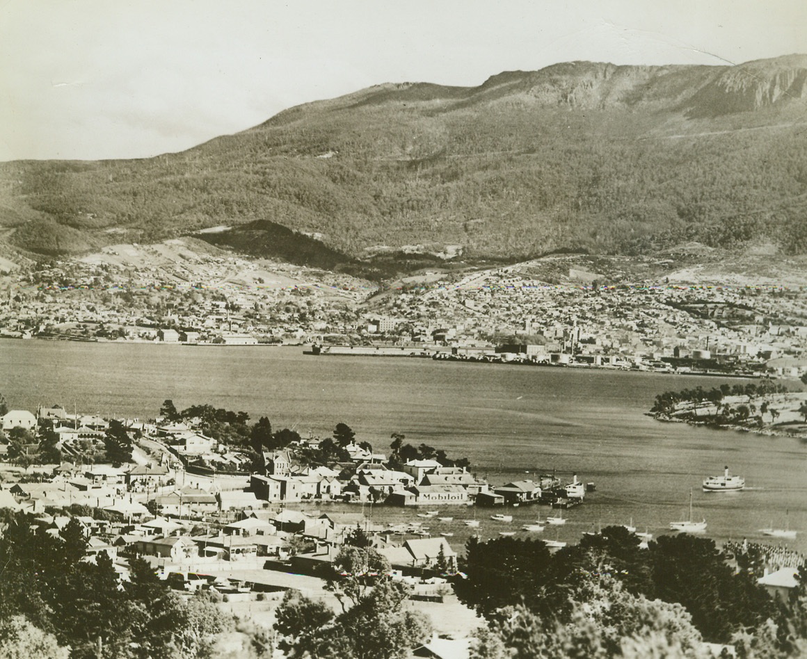 Tasmanian Capital, 3/14/1942. The island of Tasmania, which lies off the Southeast coast of the Australian mainland, is another possible invasion point in the Jap surge through the Southern Pacific.  Here is a view of Hobart, Tasmania’s capital.  Mt. Wellington dominates the Harbor.  Hobart is the Southernmost of the Australian capitals.Credit Line (ACME);