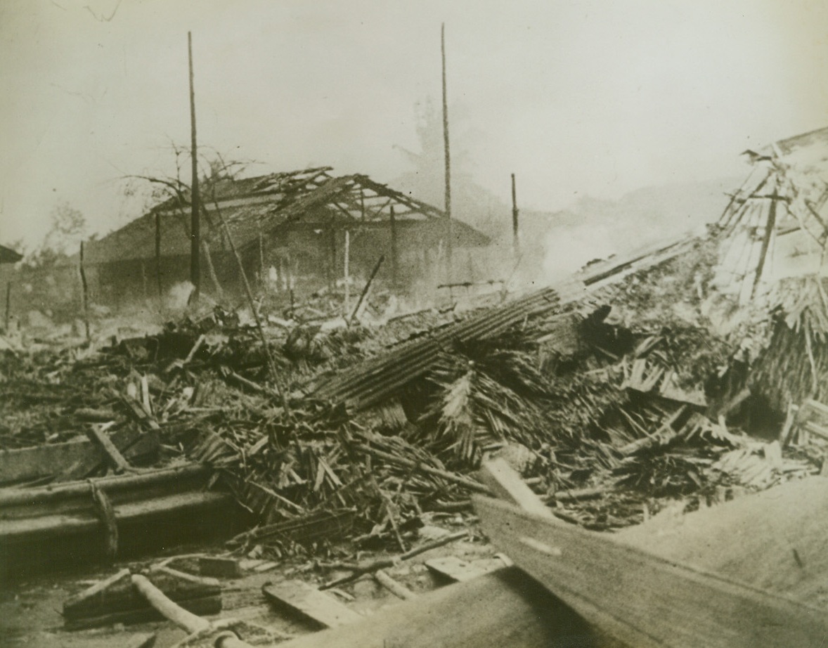 JAPANESE TOUCH ON SINGAPORE, 3/8/1942. SINGAPORE, MALAYA—Frail native huts are masses of smoking and splintered ruins after a visit by Japanese bombers during the last few days of British possession of the Malayan capitol. Credit: Acme;