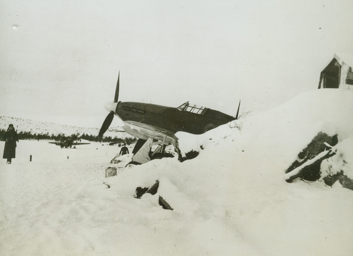 BRITISH “HURRICANES” SNOWED IN RUSSIA, 3/12/1942. ON THE NORTH RUSSIAN FRONT—British “Hurricane” fighters snowed in their dispersal bays, “Somewhere in North Russia.” These planes, with their replacement equipment, were turned over to the Russians by British flyers to help prevent a German push through Norway into Northern Russia. Credit: ACME.;