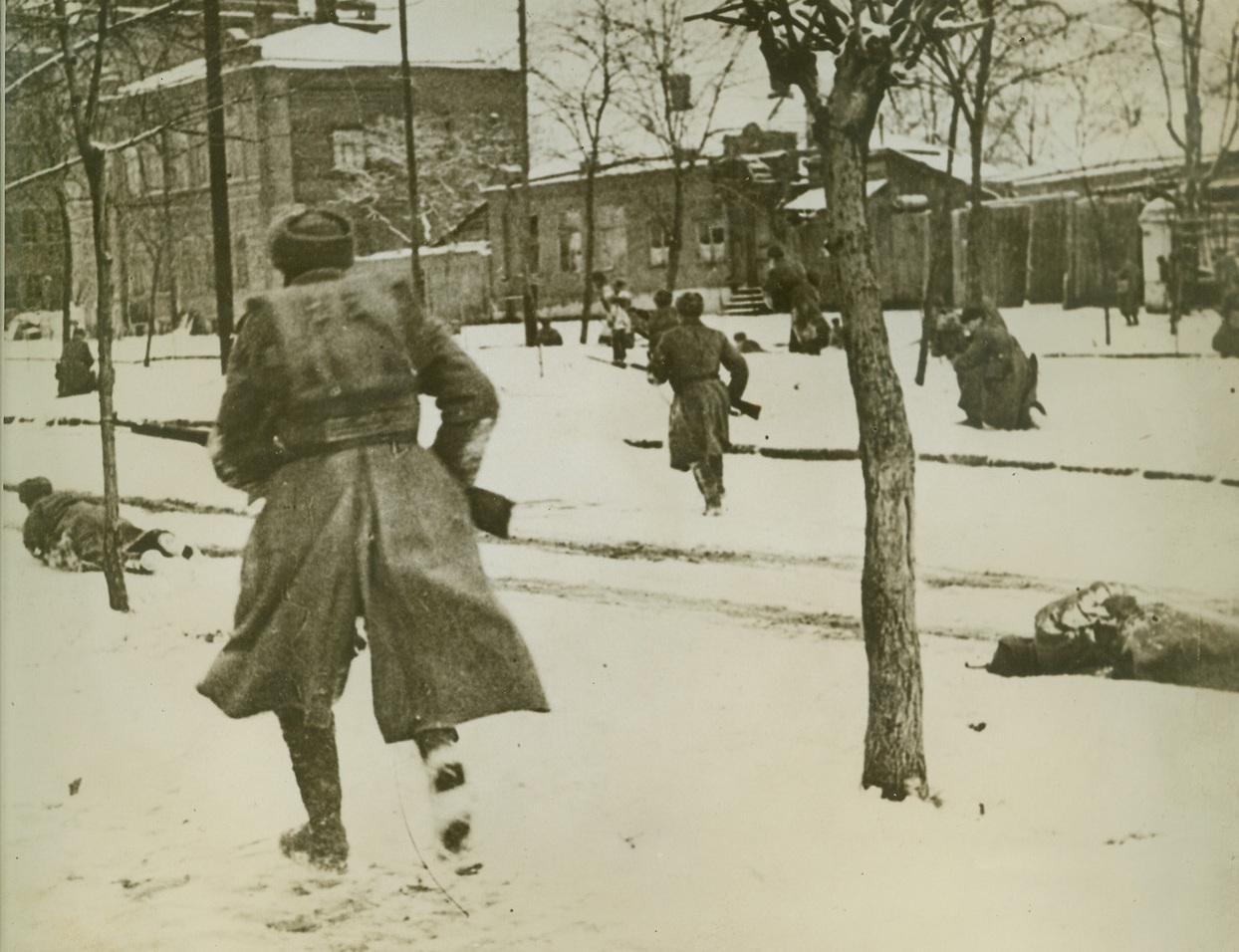 Russians Pursue Retreating Germans, 3/8/1942. ROSTOV-ON-DON, RUSSIA—One of the most graphic action pictures to come out of the war, this Russian Ministry of Information photo shows Soviet soldiers hunting down German stragglers in retaking the city of Rostov-On-Don in November, 1941. One Russian, at right, has apparently fallen, never to rise again, and another at left may be hit. Passed by censor.Credit: ACME;