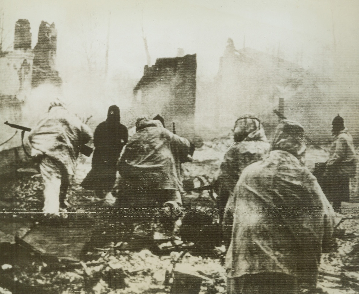 The Capture of Yukhnov, 3/25/1942. Yukhnov, Russia – Column of Russian troops as recaptured the town of Yukhnov, left in ruins by the Germans. The town was occupied by Red troops on March 5, according to Soviet dispatches. (Passed by Censors). Credit: ACME;