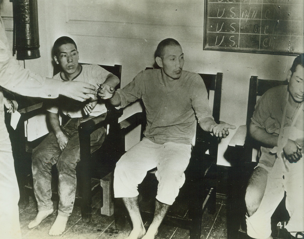 Jap airmen captured after Filipino attack., 3/30/1942. This picture released on March 30th is one of the first brought out of the Philippines since the start of hospilities.  It was rushed from Australia to the capital for release by the pictorial branch of the War dept., Bureau of Public Relations.  Photo shows – Three Japanese aviators who were shot down and taken prisoner during the raid on Manila. Credit line (U.S. Army photo from ACME);