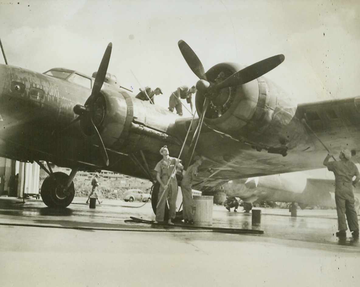 Giving Baby a Bath, 3/21/1942. Panama Canal Zone—Just in from a patrol over the vital Panama Canal, a big Army four-motored bomber gets a scrubbing before being put to bed by its watchful mechanics.Credit: ACME.;