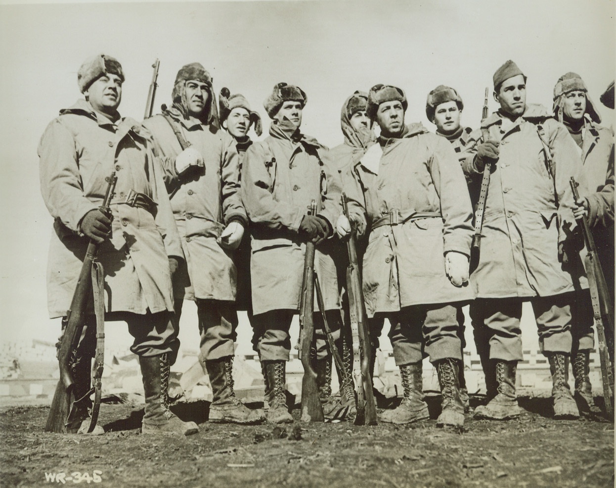 HELPING BUILD ALASKAN HIGHWAY, 4/3/1942. BRITISH COLUMBIA – American fighting men looking remarkably fit and well-fed, are shown on duty on the new U.S. to Alaska Highway. Front row, left to right: Pvt. George Francesconi, Chicago; Pfc. Joe Trevino, Corpus Christi, TX; Pvt. Joe Stack, Buffalo, N.Y.; Pvt. John Viveriot, Buffalo; Pvt. Don Silverthorn, Kenmore, N.Y. Back: Pvt. Henry Geyer, Pittsburgh; Sgt. A. F. Gill, Warrior Run, PA; Pfc. John Sadler, Valley Mills, Tex.; Pvt. W.R. Mullins, Detroit, Tex. Credit: OWI Radiophoto from ACME;