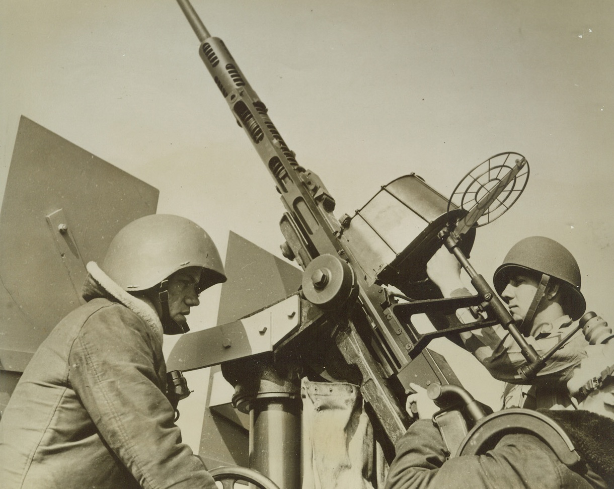 “Ack-Ack” Gunners in the Atlantic, 4/18/1942. At Sea—Anti-aircraft gunners of a warship of the U.S. Atlantic fleet are shown at their stations as the fleet goes about its business of keeping the sea lanes of the Atlantic open for United Nations shipping. This job is as vital as any of our war effort, for supplies must reach our Allies in Britain and Russia—and they are doing so. (Approved by U.S. Navy) Credit: ACME.;