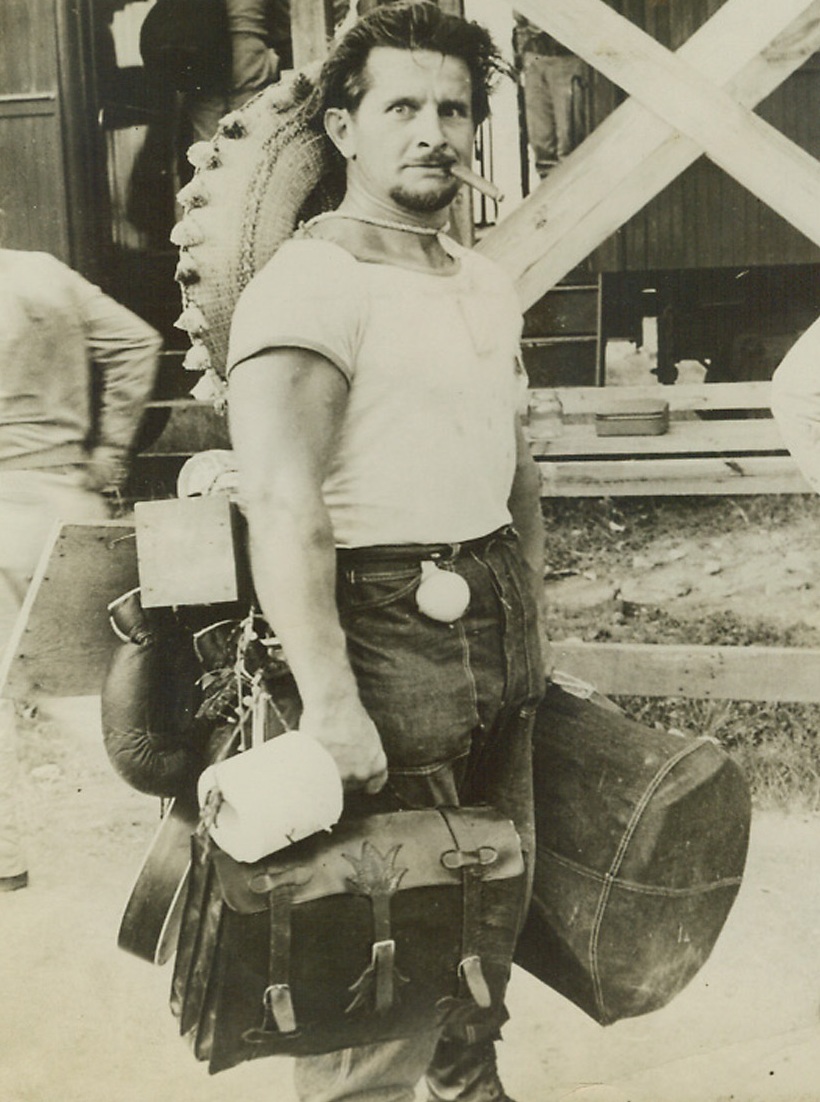 Enemy Aliens Shipped From Panama Canal Zone, 4/7/1942. Otto, an enemy alien, is equipped for “any emergency” as he leaves his internment camp in the Canal Zone. As No. 1 man of the German faction interned, he was their unofficial mayor, and directed all activities of the group in confinement. He was evacuated along with many other alien enemies to camps in the United States. Utmost secrecy prevailed in evacuation of the group to protect them from their own submarines. (Passed by censor).;