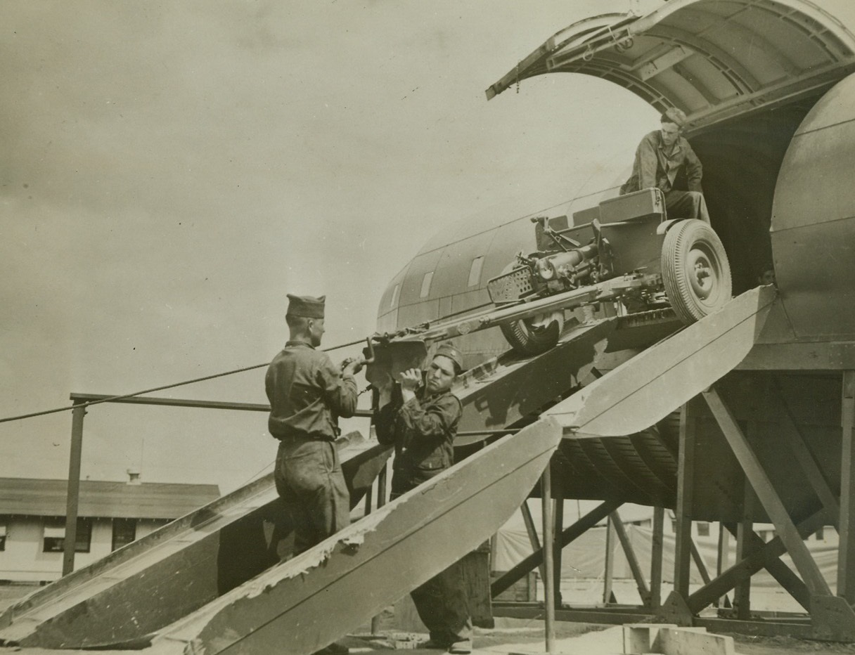 U.S. Army Trains Its Infantry, 4/20/1942. Keeping abreast of the speedy development of the modern science of warfare, the U.S. Army is gradually developing the means of transporting whole armies and their equipment--when necessary--by air. At a training camp “somewhere in the United States,” airborne infantry is being trained to move fast and far with all their equipment--cars, guns and men--as self-contained units capable of landing, attacking and holding important objectives. Practicing during their preliminary phases on replicas of giant air transports called “mockups,” they later advance to training with real planes. Here, a gun crew unloads its anti-tank gun after theoretically landing at its objective. Credit: U.S. Army Signal Corps photo from ACME;