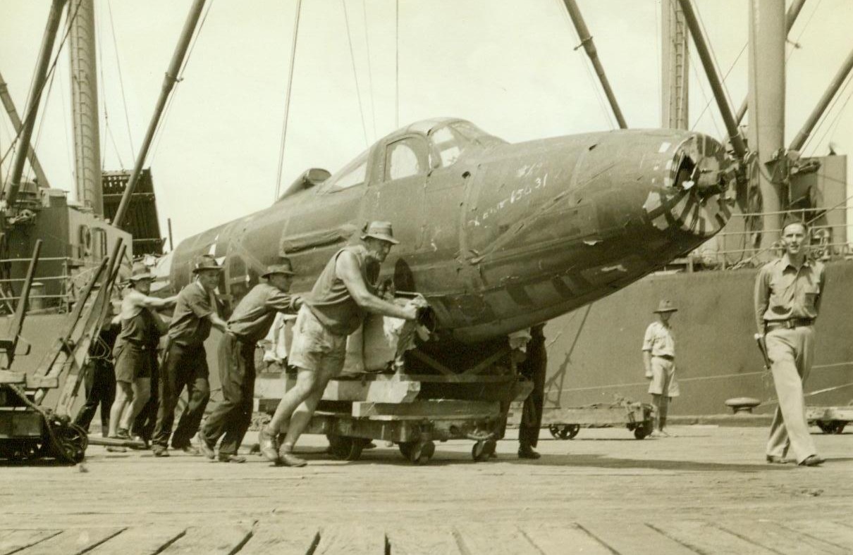 Air Defender From U.S., 4/18/1942. Australia – A deadly U.S. Aircobra fighter plane is unloaded in an Australian port from A U.S. transport which crossed the Pacific in a convoy rearing American troops and war supplies.  4/18/42 (ACME);