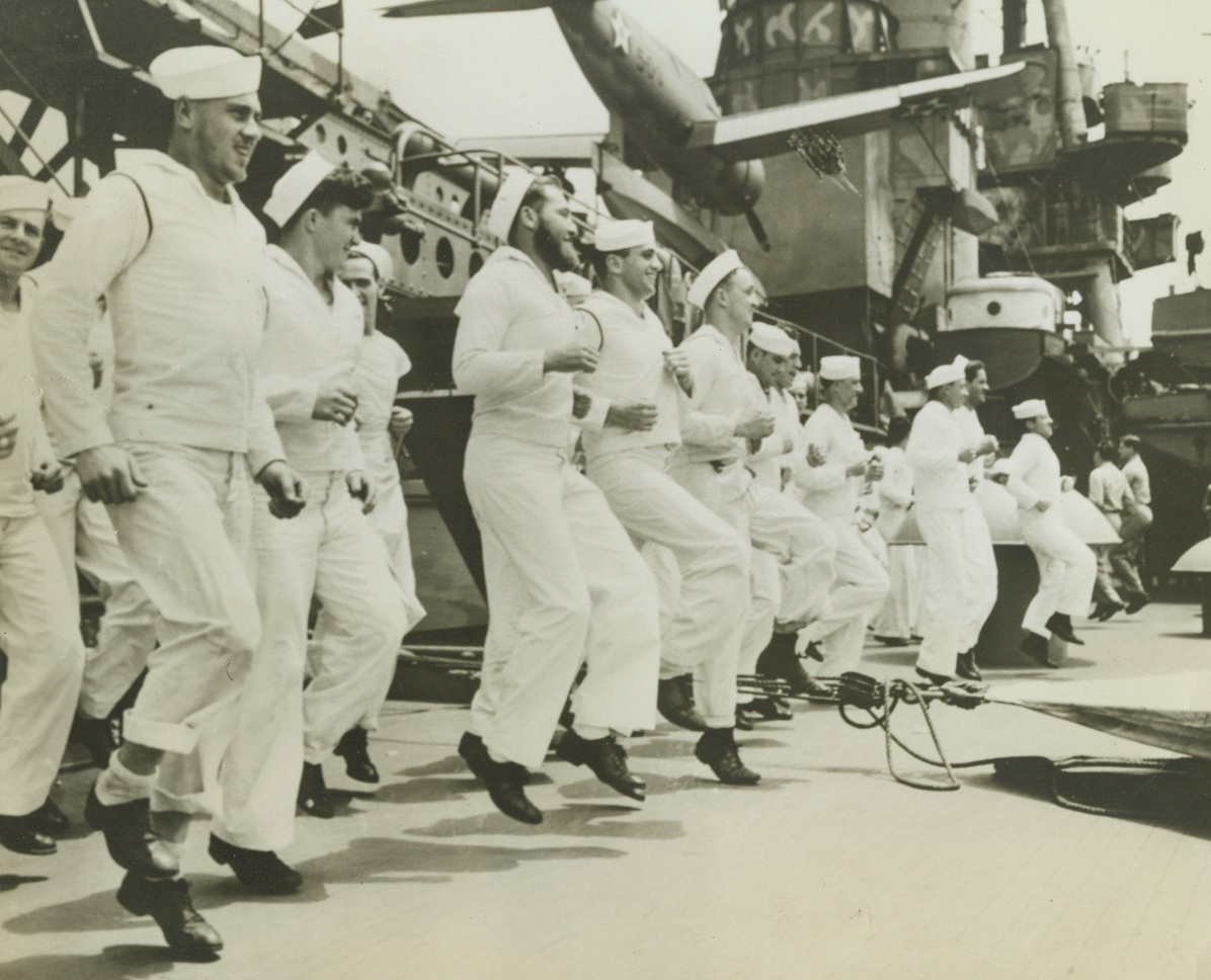 Keeping in Fightin’ Shape, 5/13/1942. Atlantic -- Sailors go through physical drill  aboard an American warship guarding a convoy in the Atlantic Ocean. One gob sports an extra-heavy beard. Credit: ACME;