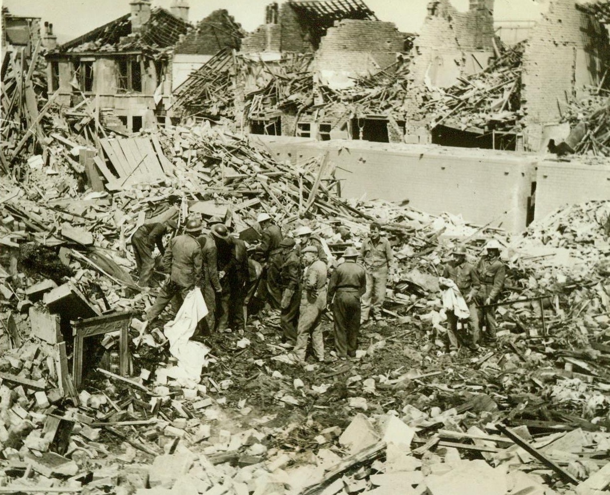 After Nazi Reprisal Raid, 5/18/1942. England - Civil Defense workers search the ruins of buildings bombed in the recent German reprisal raid on Bath, a village in Southwest England which housed evacuees from blitzed areas. In background are air raid shelters which remained intact although structures all around were shattered. (Passed by Censor) Credit: ACME;