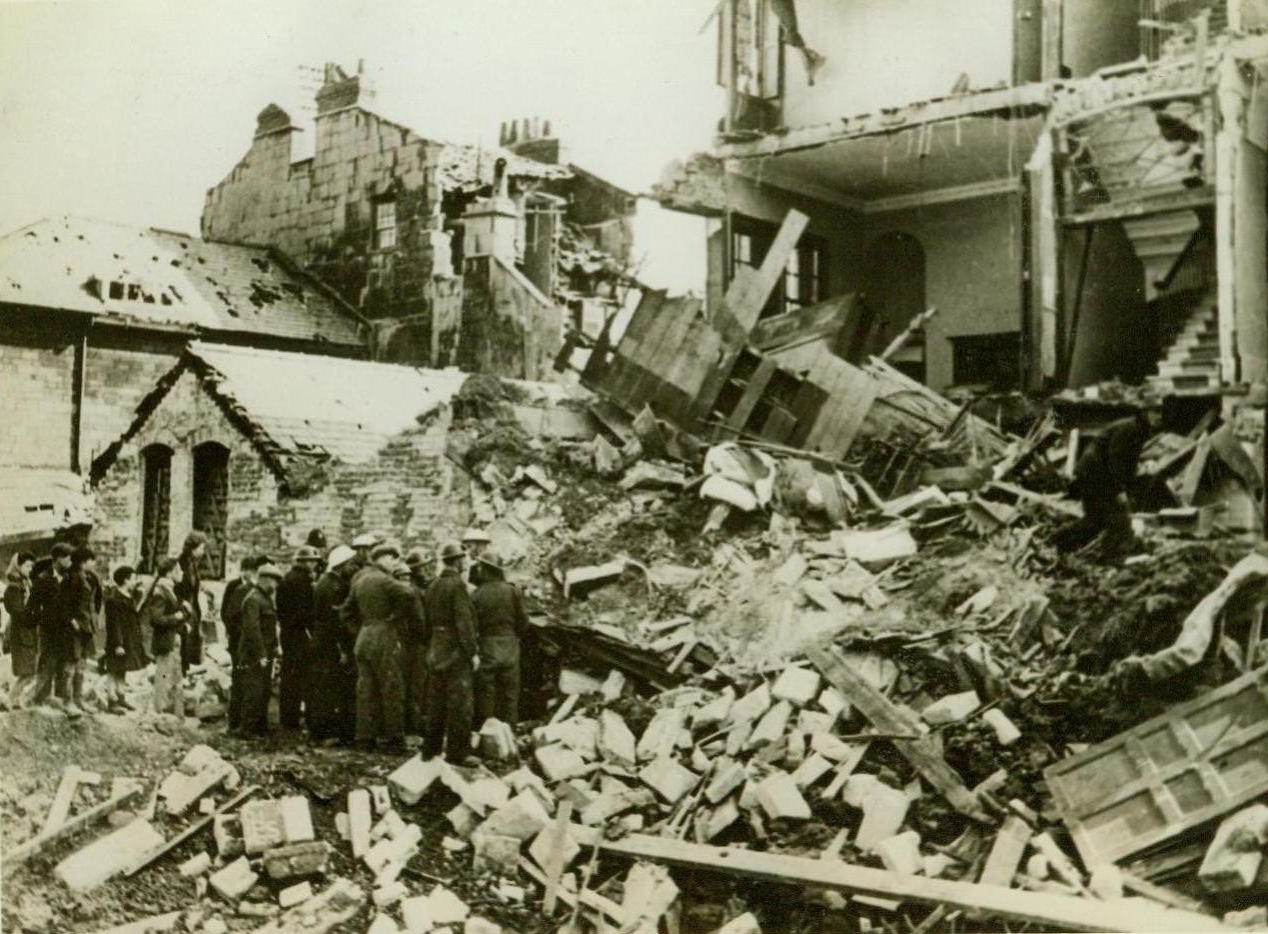 Rescue Family Trapped In Blitzed Home, 5/18/1942. England - A family was rescued from the basement under the mound of debris of this bombed house, wrecked in the second vicious reprisal raid on Bath, a village in Southwest England. Many children had been evacuated there from bombed areas. (Passed by censor) Credit: ACME;