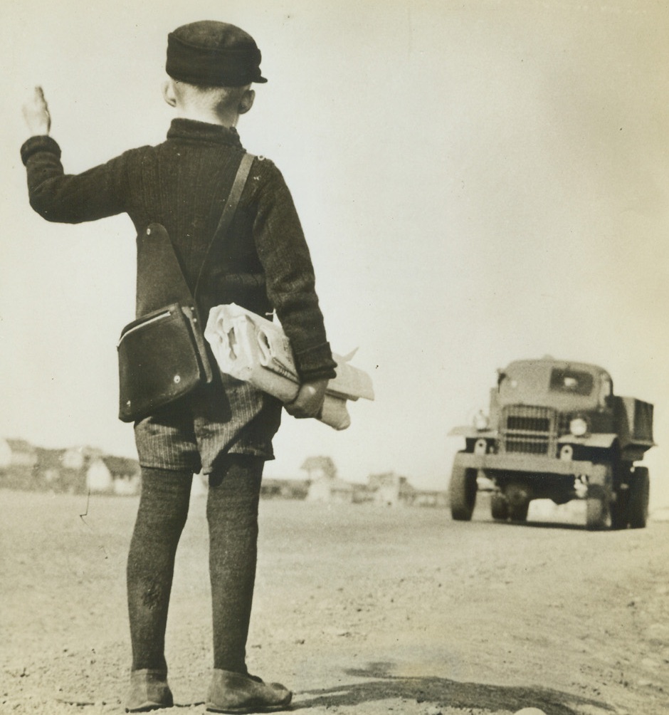 Hitch-Hiking in the Iceland Manner, 7/28/1942. Taking advantage of the opportunity offered by the sight of an approaching United States Army truck of our forces in Iceland, this young schoolboy uses the universal thumb method to hitch a ride to his school house.  Credit Line (Official U.S. Army Photo from ACME);