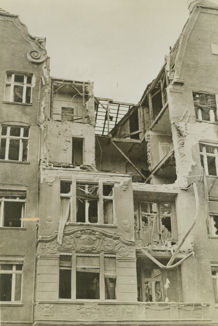 Berlin After Bombing, 7/7/1942. BERLIN, GERMANY – Here is a bomb hit on a building on Meineke Strasse, Berlin, next to the headquarters of the capital’s Anti-Air Raid Division No. 1. If ever the RAF carries out one of its 1,000-plane raids over the city, scenes like this one will be seen throughout Berlin. Credit Line (ACME);