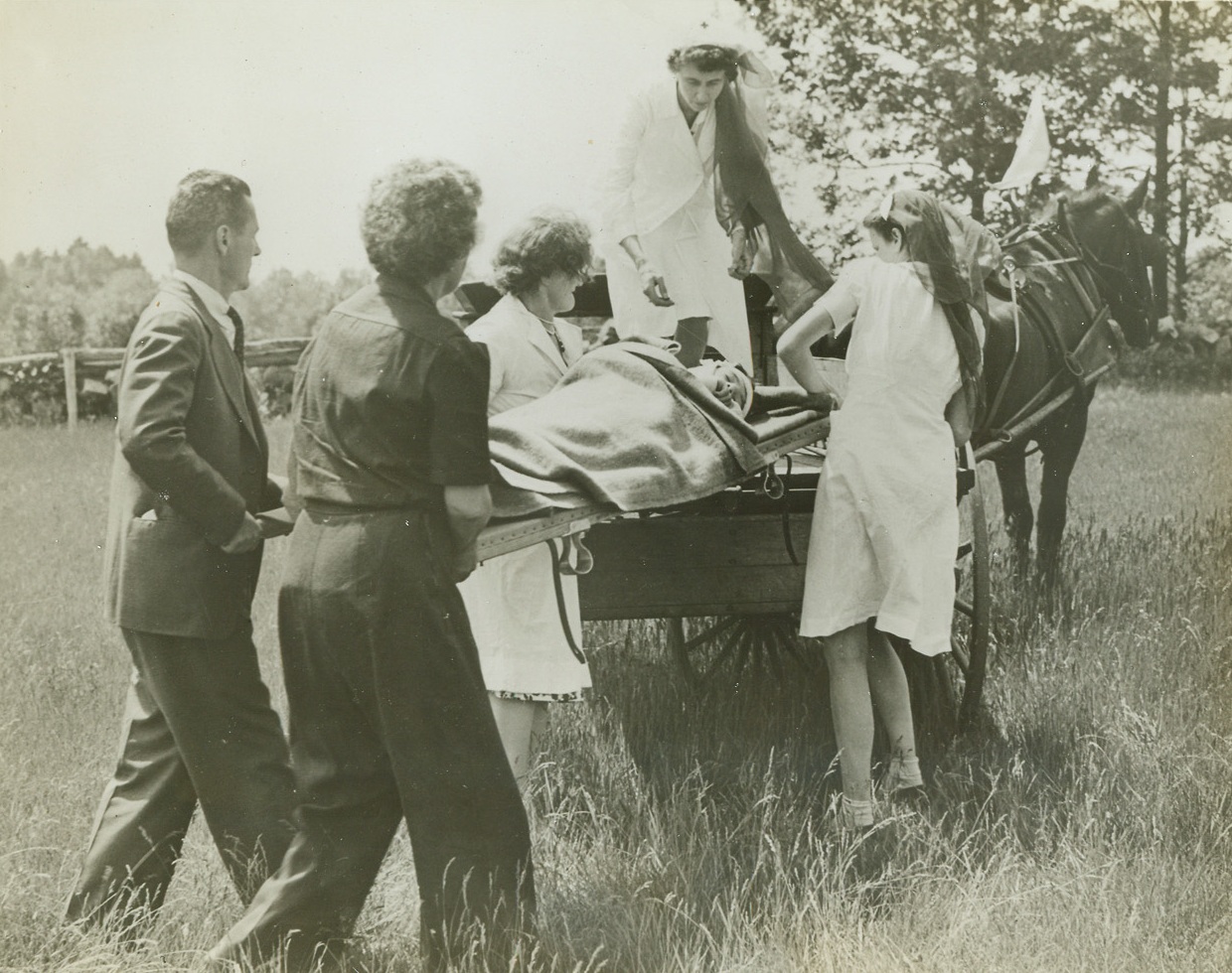 Ready for Gasless Emergency, 7/28/1942. Boston, Mass.—This Red Cross unit is preparing for wartime emergency, using “Dobbin” and a wagon instead of gasoline-burning ambulances for their first aid practice. The group is from the Volunteer Motor Corps of the Medfield Branch of the Boston Red Cross Chapter, and they have organized a “horse corps” composed entirely of horse-drawn vehicles.Credit: ACME.;