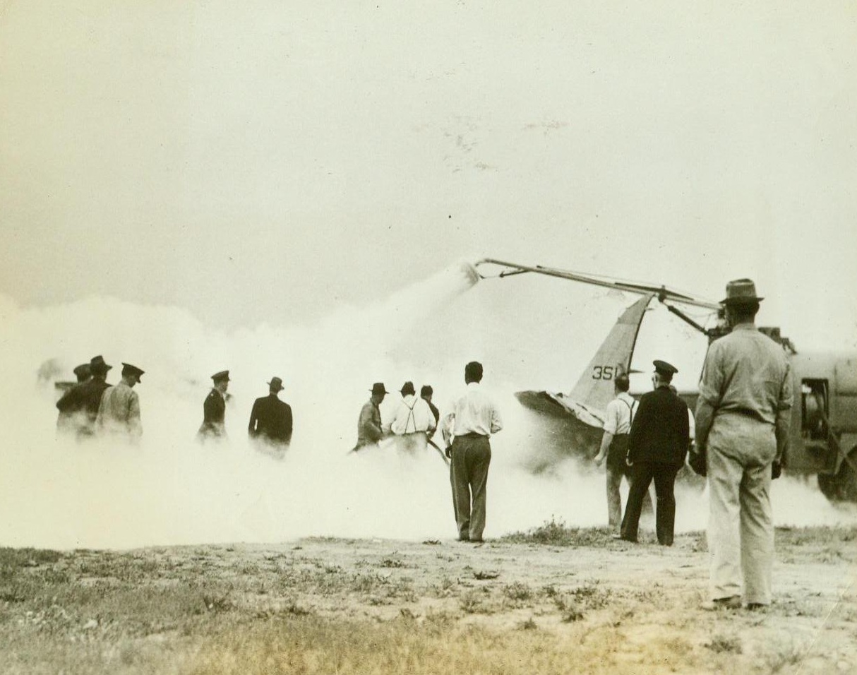 New Air Force Crash Truck, 7/24/1942. Research activities at a U.S. flying field have developed a new life saving device – a fire fighting crash truck, designed to save the lives of men in our Air Force. The truck which can smother a fire by throwing thousands of pounds of Carbon Dioxide on a burning plane in 3 minutes, proved to be a success after being tested. Photo shows the crash truck, not only driving back the flames, but cooling the hot metal to allow rescue of the occupants. 7/24/42 (ACME);