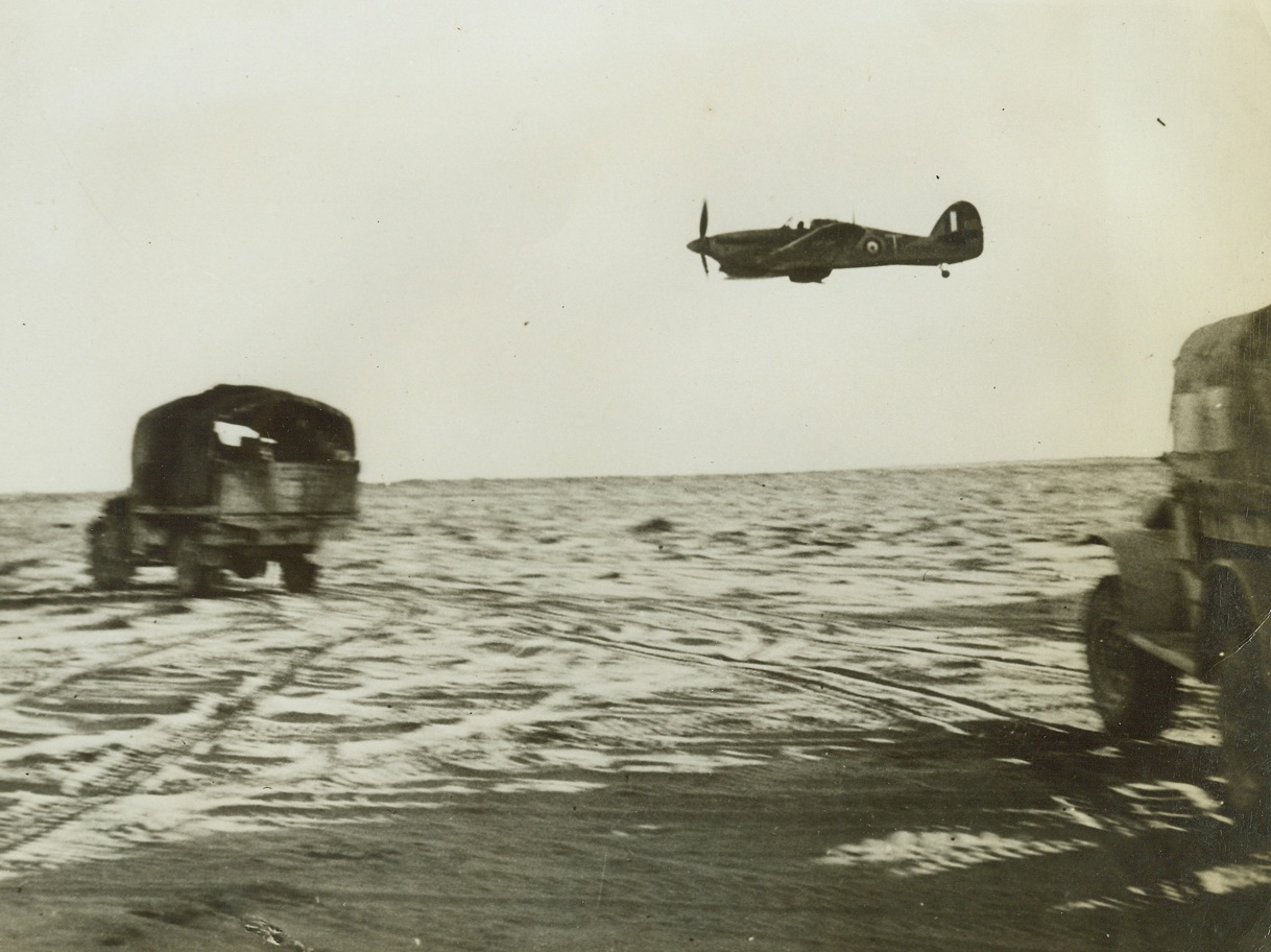 New Zealanders in Battle of Egypt, 8/3/1942. These photos of New Zealanders in the Battle of Egypt were taken by official photographers during action on the El Alamein front. Fierce New Zealand troops have joined other United Nations forces on the fighting front, and have done much to stem the Axis march toward Alexandria, Large British Naval Base in Egypt. These are said to be the first pictures of New Zealanders’ participation in the Western Desert Campaign during June and July, 1942. Low-flying fighter plane patrols New Zealand colums as they leave Mersa Matruh bound for Minqar Qaim to make contact with the enemy. Only once, at the beginning of this campaign was the transport bombed Credit Line (ACME) 8/3/42;