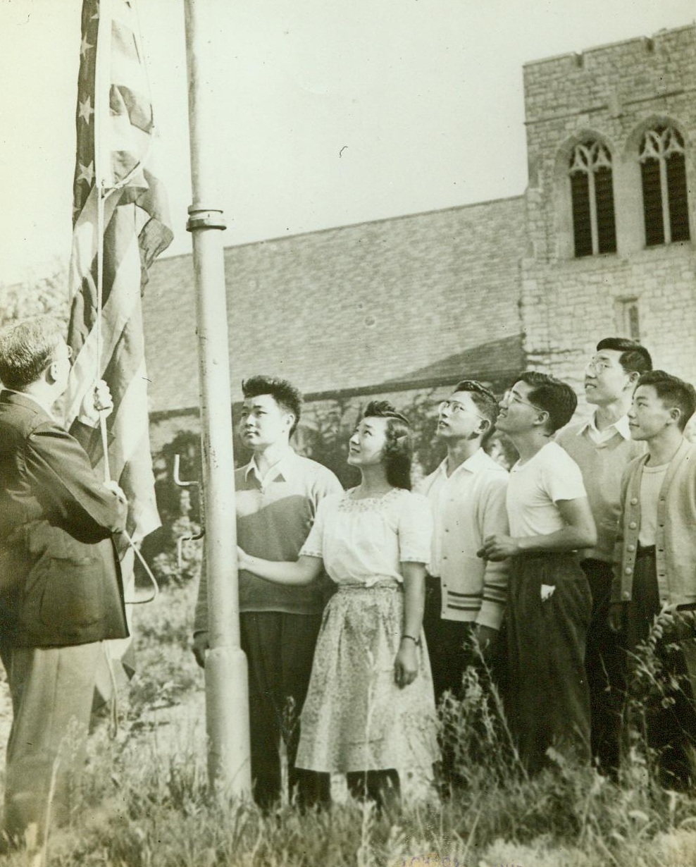 Japanese Students Under Fire, 8/29/1943. Parkville, MO. – American-born Japanese students at Park College, Parkville, Mo., take part in flag raising ceremony and calmly continue studies there despite protests of citizens of Platte County, Mo., who believe they should be interned. Left to Right; W.L. Young, College President; henry Masuda, Toki Kumai, Arthur Kamitsuka, William Yamamoto, Abraham Dohl, and Peter Mori. 8/29/42 (ACME;