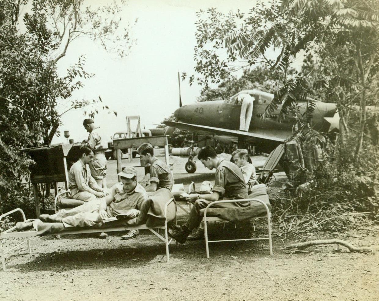 U.S. Fighter Plane Base In Caribbean Area, 8/13/1942. Hidden away in the Caribbean area these fighter pilots of Uncle Sam’s Air Forces are ever on the alert in their dense jungle bases. During a “stand-by alert” they remain beside their planes as the engines are warmed up by ground crews 8/13/42 (ACME);