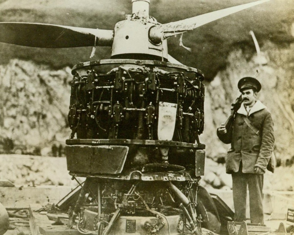 Motor Of Wrecked Jap Plane, 8/8/1942. Washington, D.C. – Proof of the power and maneuverability of Jap fighting plans is this huge motor taken from a carrier-based plane which crashed in a mountainous section near Dutch Harbor, Alaska, during a bombing attack. The motor, in comparatively undamaged condition, is guarded by a U.S. Marine sentry pending study by U.S. aeronautical experts 8/8/42 (Official U.S. Navy Photo- From ACME);