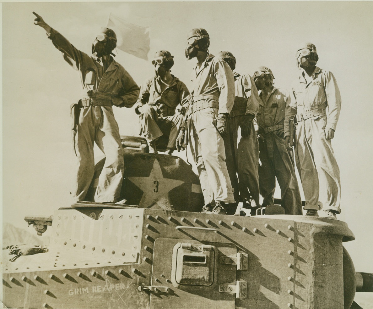 THEY LEARN ART OF DESERT WARFARE, 8/27/1942. WITH U. S. ARMY IN CALIFORNIA DESERT – Wearing goggles and air filters, these U. S. tank crewmen learn the art of desert warfare as mechanized and motorized forces of the U. S. Army begin battle maneuvers somewhere in the California desert. War time touch is the name of the tank – “Grim Reaper.” Credit: ACME;