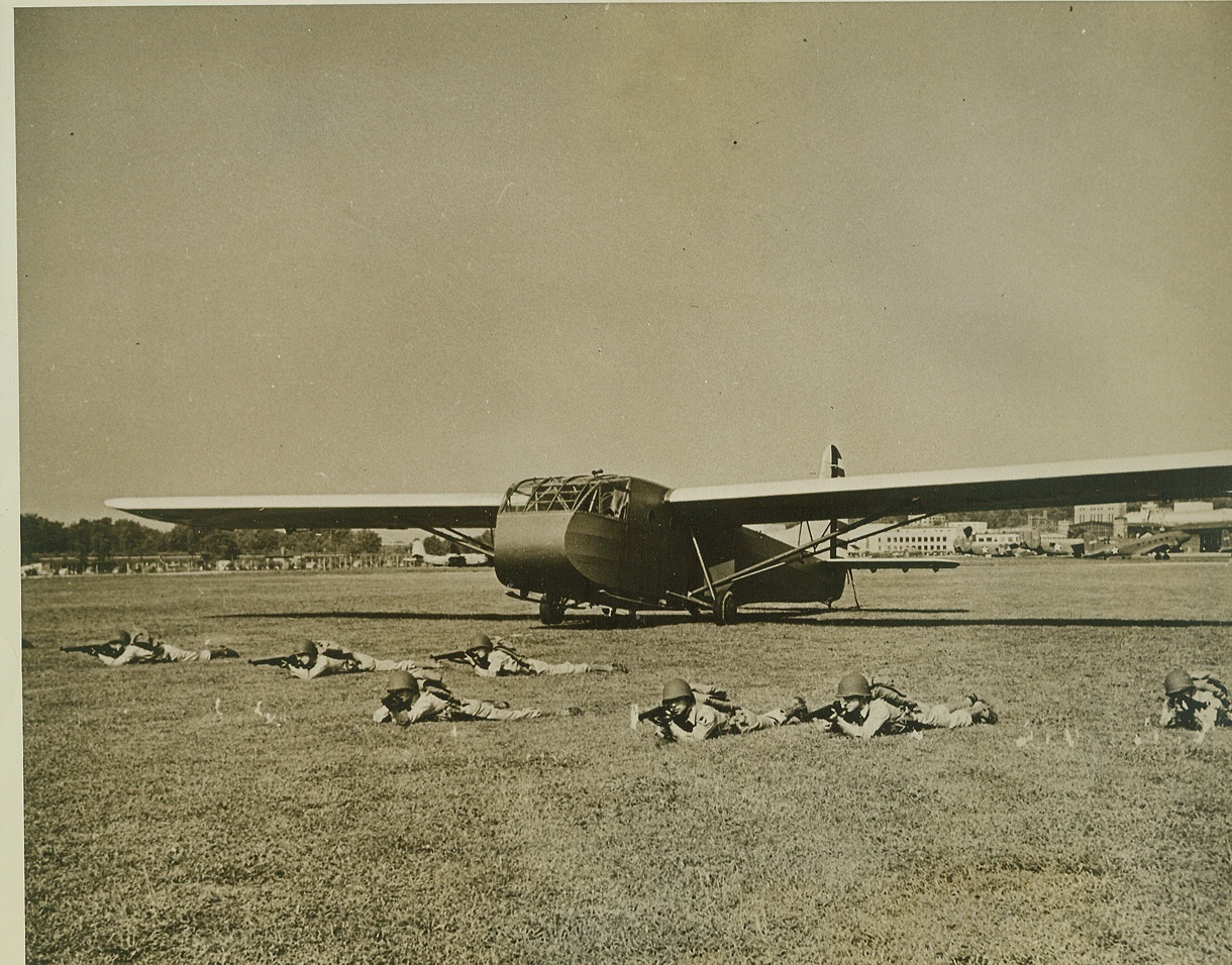 New Troop-Carrying Glider in Production, 8/27/1942. Air-borne infantry have landed in this new U.S. Army Air Forces CG-4A 15-place glider and are ready for action. This practice maneuver may soon be repeated many times over "for real", for gliders of this type will soon be our first line of offense in invasion against the Axis. The craft are now in quantity production by Boeing, Beech, and Cessna at Wichita, Kansas, and skilled pilots are being turned out for them by the Army Air Forces. In spite of their size, these gliders weigh only about 3,000 pounds, and two or more of them can land in almost any small field or pasture. Credit: (ACME);