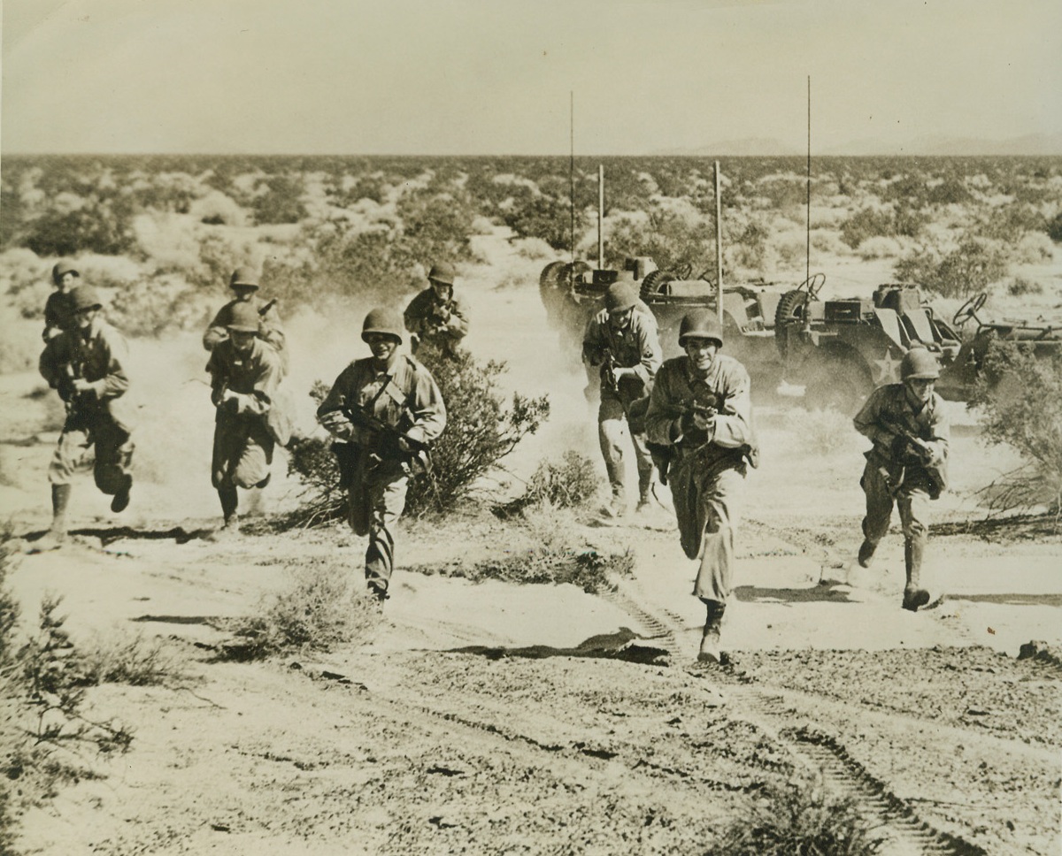 Infantrymen of the Desert, 8/27/1942. With U.S. Army in California Desert—From their armored cars, these hard-bitten U.S. soldiers leap forth to battle as the U.S. Army began battle maneuvers somewhere in the California desert. Credit: ACME.;