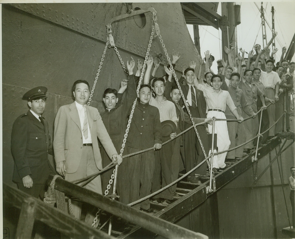 SHORE LEAVE, 8/4/1942. Tsune Chi-Yu, Chinese Consul General at New York, leads a group of Chinese seamen ashore at an east coast port after notifying them, on their arrival, of a new agreement with U.S. Immigration Authorities permitting China’s sailors for the first time to come ashore when docking in U.S. ports. Credit: ACME;