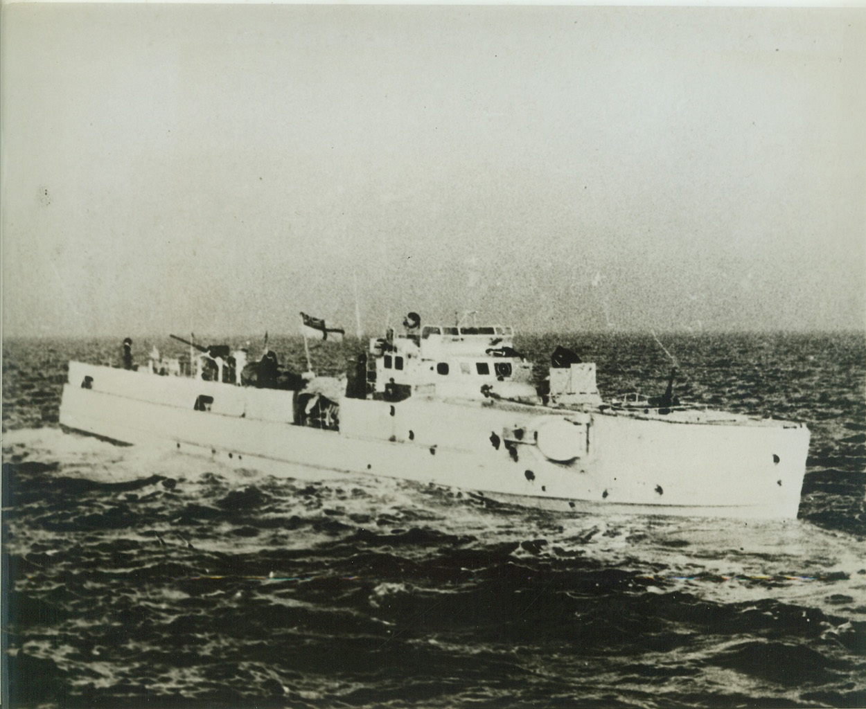 FIRST PHOTO OF CAPTURED GERMAN E-BOAT, 8/5/1942. This is the first photo of a captured German E-Boat to reach the United States. These boats, the counterpart of our PT boats, have carried out hit-and-run attacks on United Nations shipping in the English Channel and in other parts of the world. The E-Boat in photo was captured by a small force of British Coastal craft, whose Oerlikon 20mm guns punched the many holes that show in the hull and killed many of the crew. The small vessel is equipped with torpedo tubes, depth charges, smoke floats, two 20mm guns and two machine guns. (Passed by censors). Credit: ACME;
