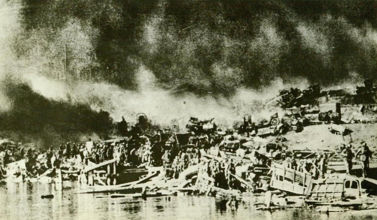 BRIDGE WRECKED BY REDS IN DON AREA, 8/5/1942. In this photo from an enemy source, German soldiers, in single file, cross over the wreckage of a bridge blown up by the Reds to halt the Nazi drive in the Don River Area of the Caucasus. Note smashed trucks and other pieces of equipment, blasted to bits in the bitter fight for this river crossing. The Nazis, still surging forward towards Red oil fields, have reached a point 100 miles southwest of Stalingrad. (Passed by Censors). Credit: ACME;