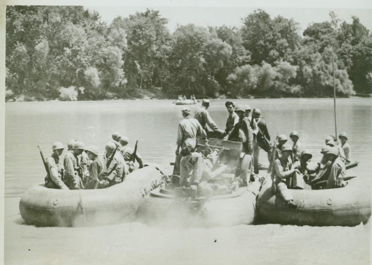Pontoon Crossing in Carolina Maneuvers, 8/6/1942. With the Army in the Carolinas—An outboard motor stirring up the quiet waters of the Pee Dee River, propels three rubber pontoons toward a bridgehead, ferrying a 37 mm anti-aircraft gun and its crew members across the river during maneuvers in the Carolinas. Credit: ACME.;