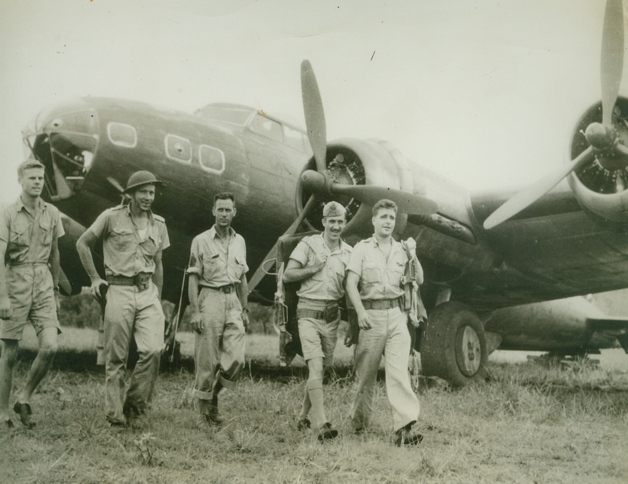 Some of Our Boys “Down There” in Australia, 8/9/1942. “Somewhere in Australia” was taken this picture—one of the first from the land of “down under” since the United States entered the World War II – shows members of an American Army Air Corps “flying fortress” crew walking in front of one of their big four-motored bombers, which, incidentally, had been in action against the Japanese invaders in the Philippines area;