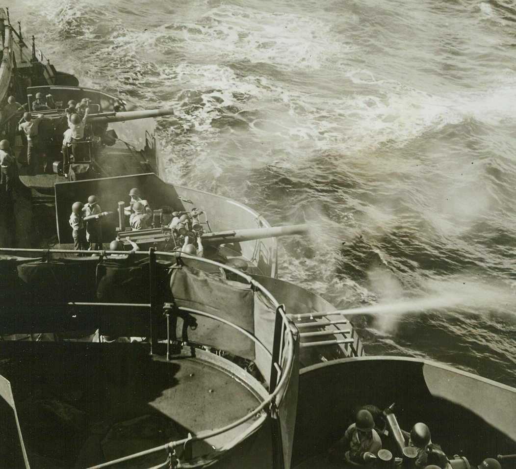 WHERE A PERFECT MARK IS “ZERO”, 9/25/1942. Big little anti-aircraft guns of a unit of the U.S. Pacific Fleet engaged as part of a task force somewhere in the Pacific fill the air with “flak” during anti-aircraft practice at sea. The larger AA’s in action here are five-inchers.Credit: ACME.;