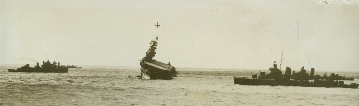 SINKING OF THE YORKTOWN, 9/16/1942. WASHINGTON, D.C.—Escort ships circle the helpless U.S.S. Yorktown, shortly before it sank to the bottom of the Pacific, June 7th, after its work was done in turning back the Japanese invasion fleet from Midway Island. The gallant aircraft carrier, which caused the destruction of at least a dozen Jap ships, was lost—but it was lost during the greatest American Naval victory of the war.  Credit: OFFICIAL U.S. NAVY PHOTO FROM ACME.;