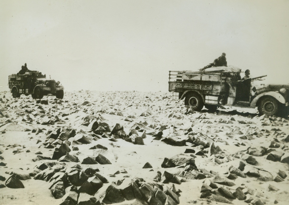 Here’s Why An Army Needs Good Rubber Tires, 9/24/1942. North Africa – Trucks of the long range desert patrol manned by picked British and New Zealand troops bump along the rock desert 100 miles South of Bengas. These patrols recently carried out attacks on Bengasi, Barce, and Gialo, and have made raids as far as the outskirts of Tripoli. Credit line (ACME);