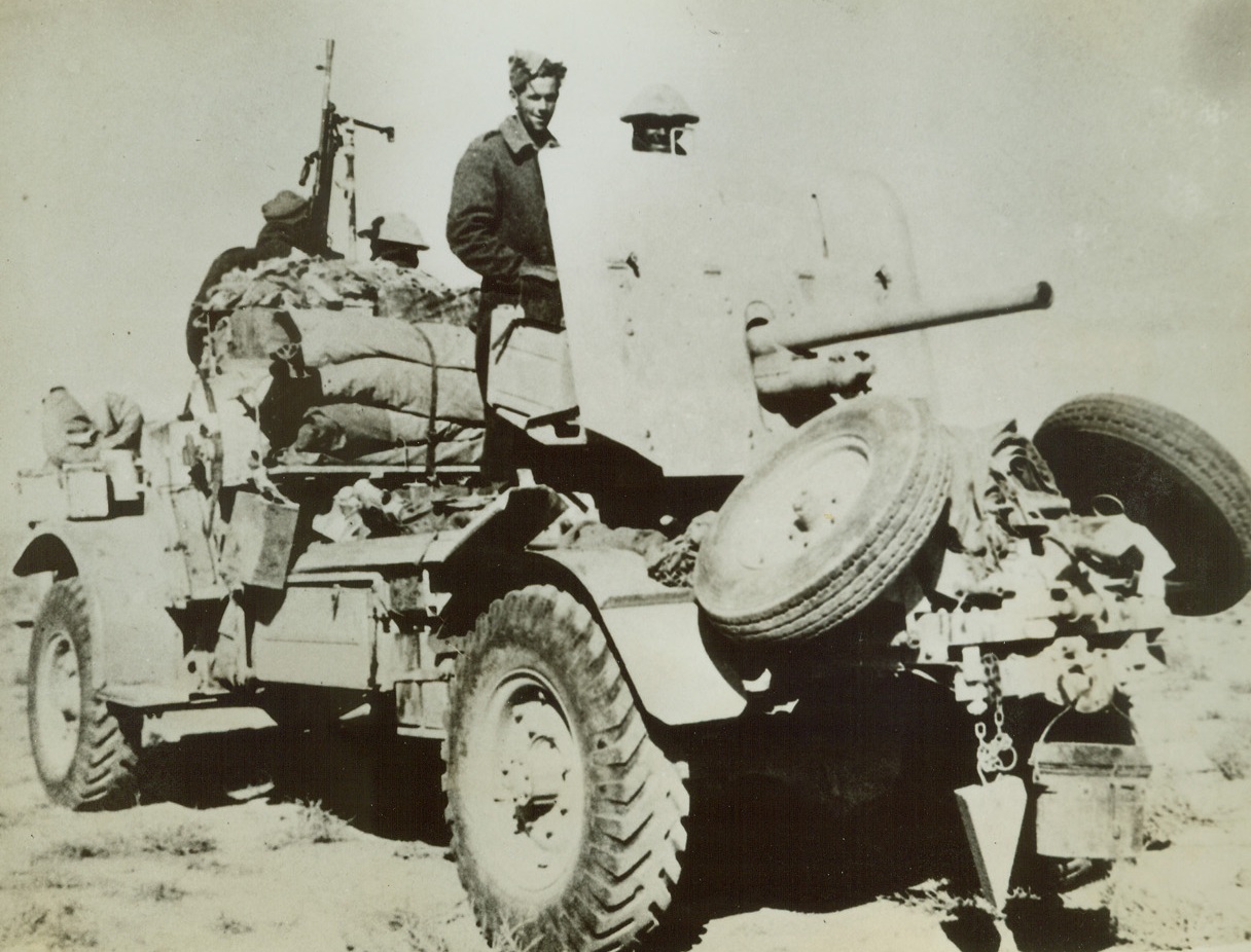 Anti-Axis Desert Patrol Guns, 9/24/1942. North Africa—Recent Allied raids into Axis positions deep in Cyrenacia depend upon special equipment such as this truck manned by New Zealanders who are members of the Long Range Desert Patrol. They are shown with an anti-tank light machine gun on a specially built carriage which carries supplies for wide reconnaissance and battle raids.  Credit: ACME.;