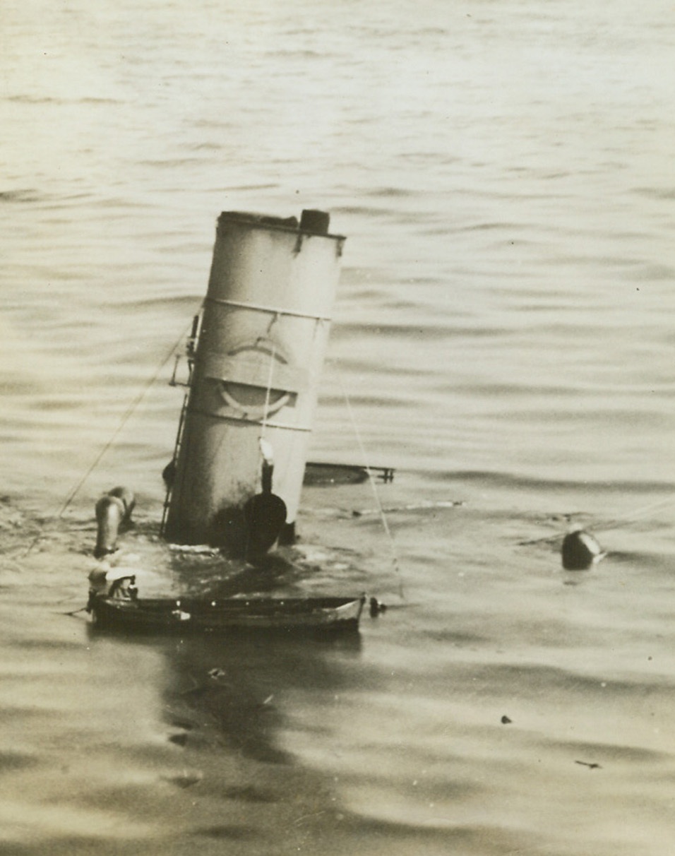 Atlantic Dilemma, 9/29/1942. You don’t have to tell this seaman of a torpedoed merchantman that the battle of the Atlantic is still in full swing. Standing on a funnel just a few feet above the surface of the swiftly rising water, he’s weighing his chances of getting away safely in a life boat which is still moored to its davits. Photo has just been released by the U.S. Navy. Passed by Navy censor. Credit: U.S. Navy photo from ACME.;