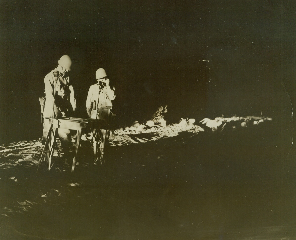 Keeping Tabs on Enemy Sky Raiders, 9/29/1942. California—The aircraft piloting crew of an anti-aircraft coast artillery unit holding a practice demonstration in the California desert (illegible portion of caption) during night maneuvers. They relay reports from the plane detector crews to a switchboard where the course of the enemy plane is (illegible word).Passed by Army censor.Credit: ACME.;