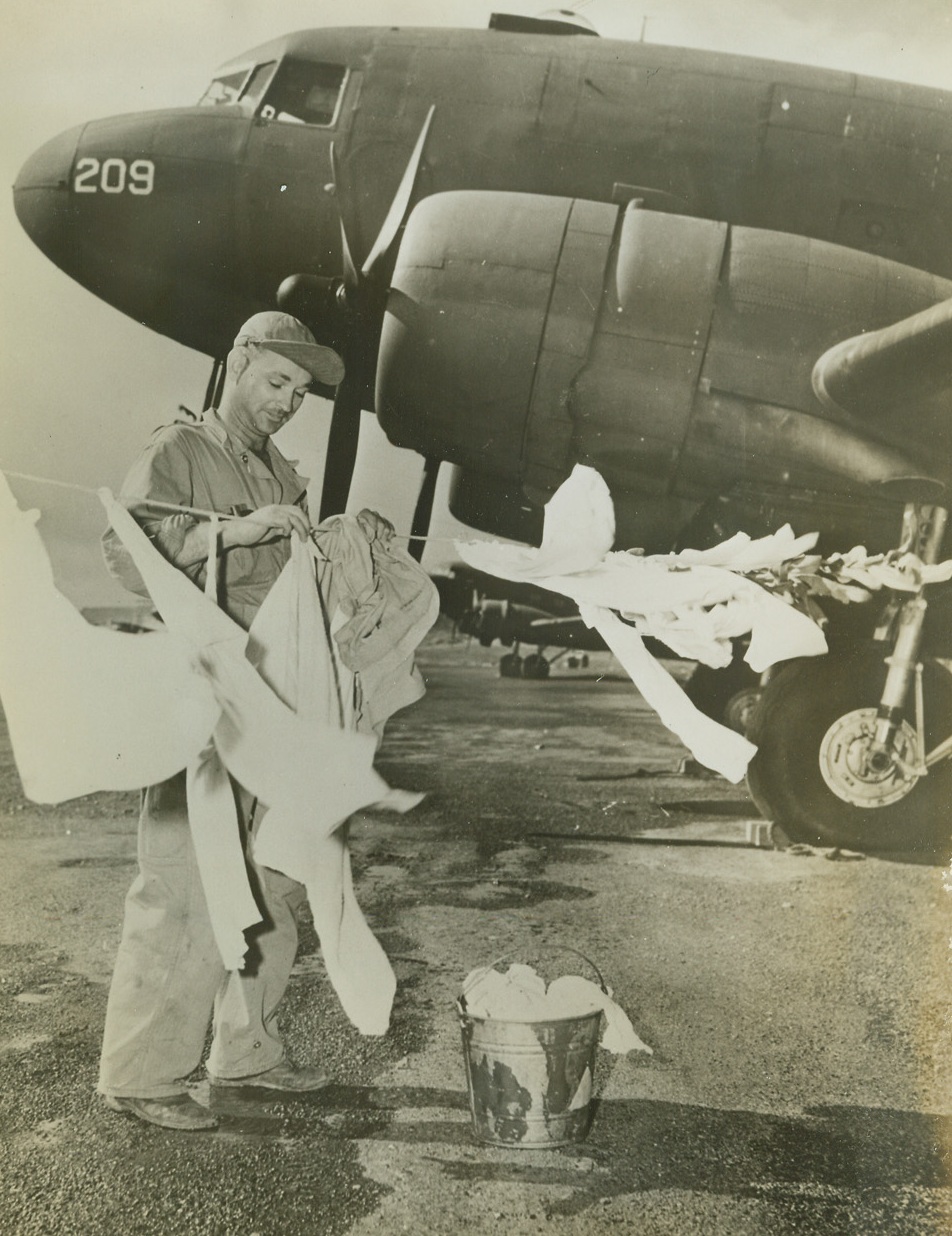 Any Day is Wash Day, 9/12/1942. Washington, D.C.—Sergeant Roland L. Judd, to whom crossing the Atlantic is all part of a day’s work in the Air Transport Command, is hoping his wash will dry before he heads for one of the many North Atlantic bases, from which a steady flow of American bombers is pouring into the United Kingdom.Credit: Official Army photo.;