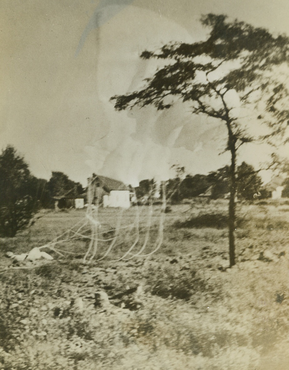 Pilot Escapes Death in Army Plane Crash, 9/12/1942. Buffalo, NY—This dramatic photo shows test pilot J. Bertrand Purnell parachuting to safety after his burning Curtiss plane crashed through the roof of a Curtiss-Wright Airplane Division plant building in Buffalo two miles away. Purnell suffered severe burns and the crash caused 12 deaths and injured 37 persons, 8 of them critically. The FBI is making an inquiry to determine whether sabotage was involved. Pilot Purnell could not explain why the plane caught fire.Credit: ACME.;